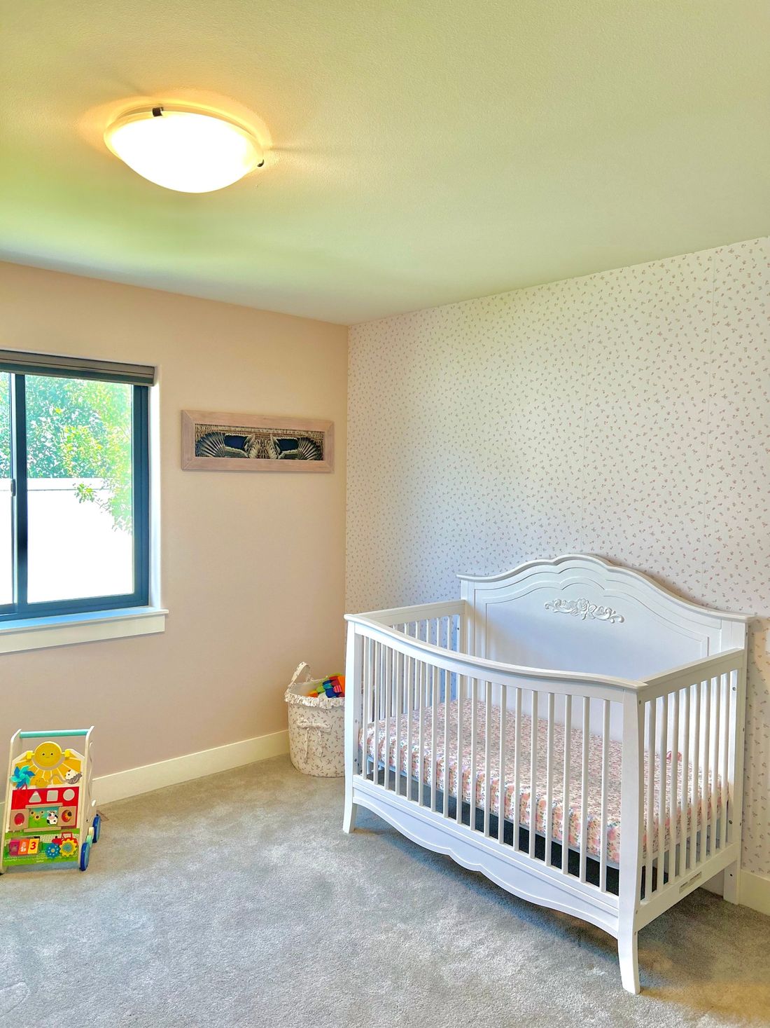 A hen mallard flying mount hanging above a white crib in a nursery